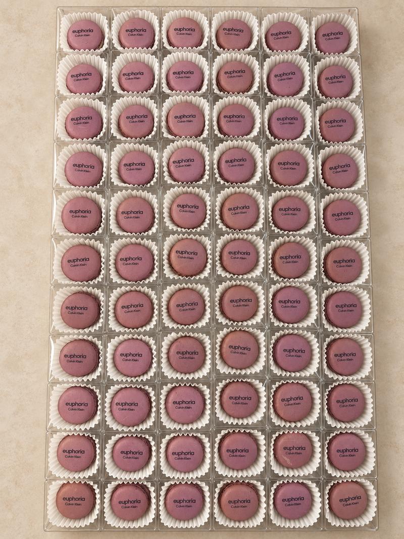 Pink Calvin Klein euphoria logo macarons in individual clear boxes