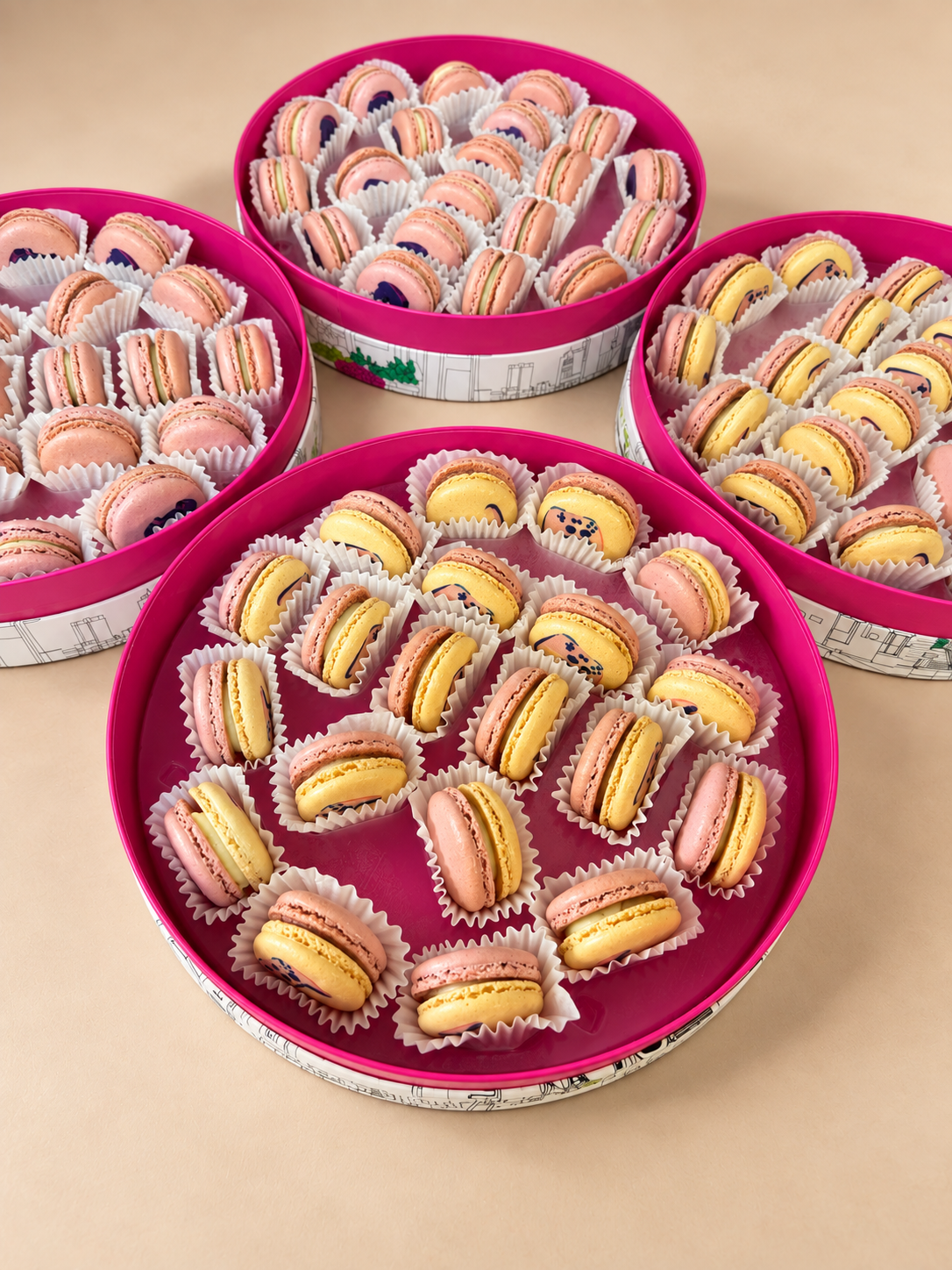 Round pink gift tins filled with French macarons