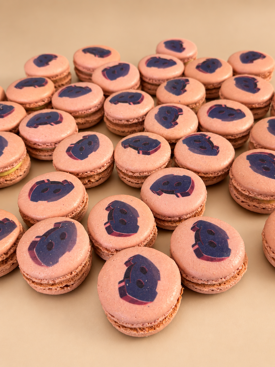 Pink French macarons printed with the purple Discord mascot