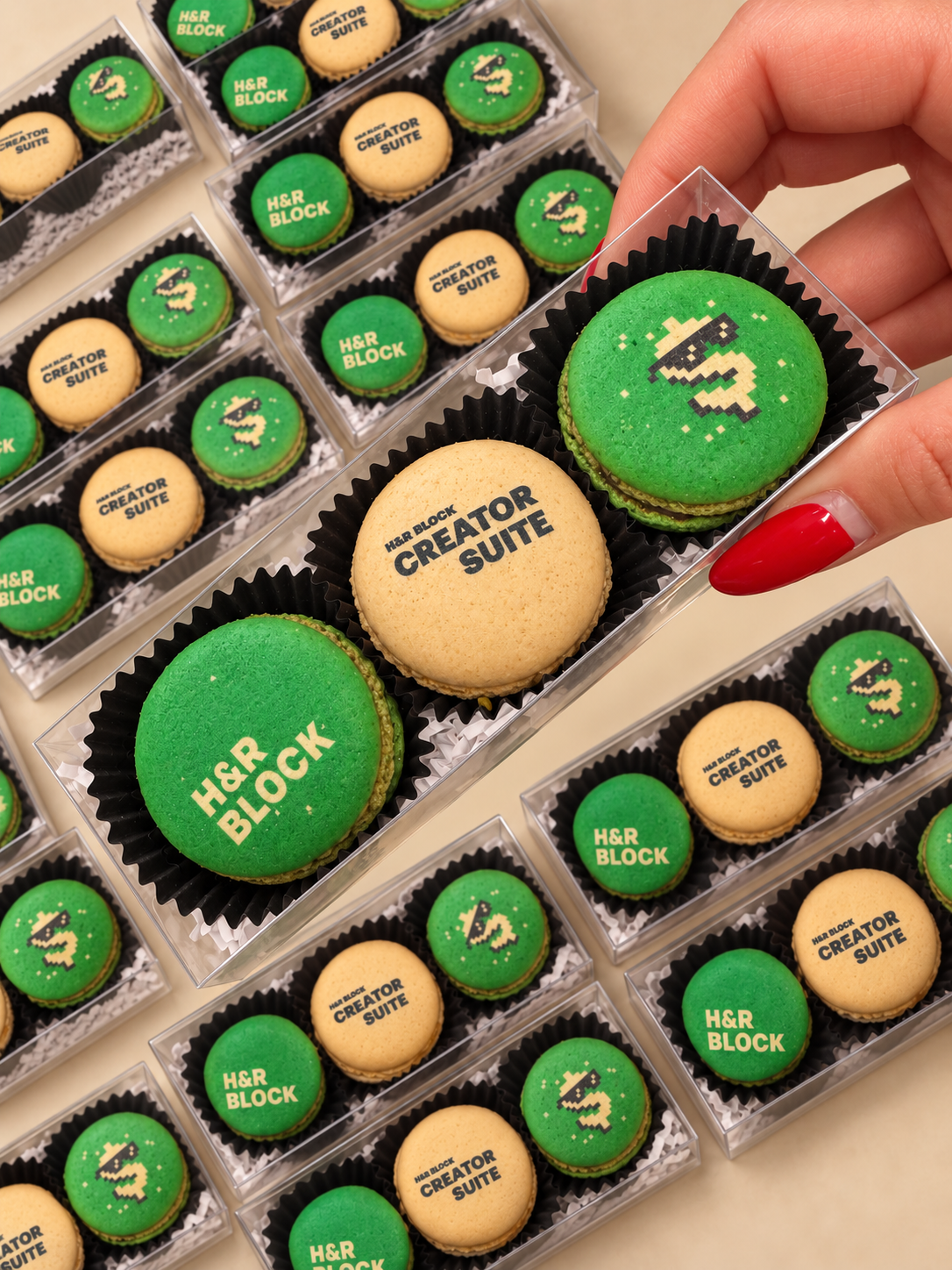 Green macarons printed with the H&R Block logo packed in clear boxes