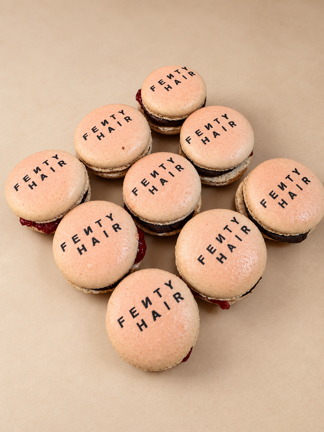 Blush macarons printed with the Fenty Hair logo