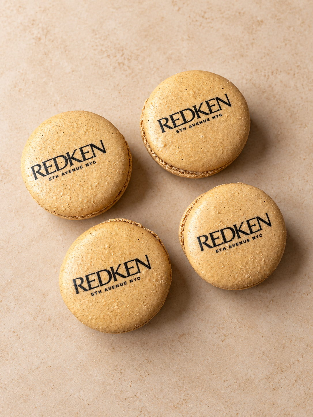 Three macarons printed with the Redken logo