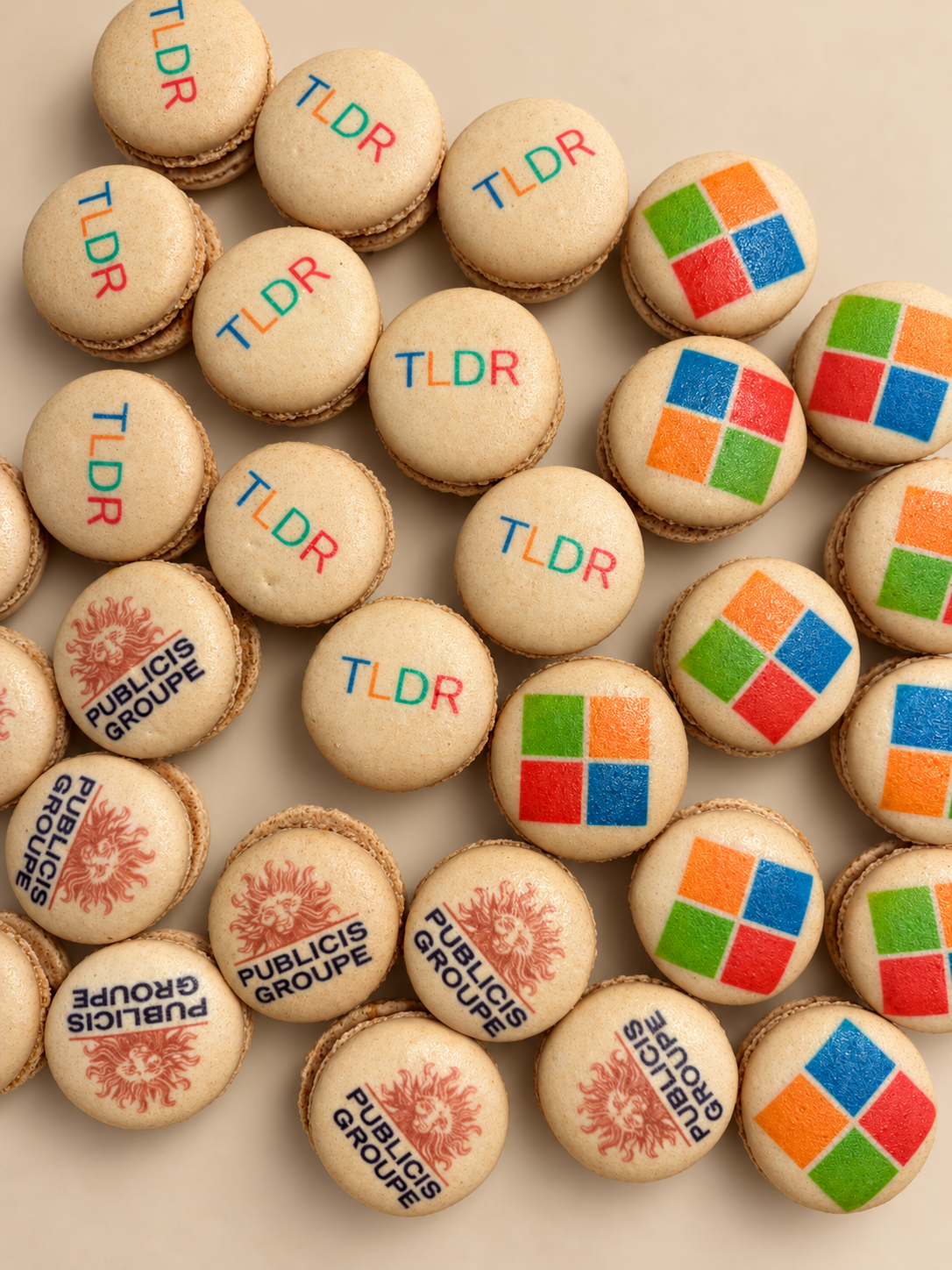 Macarons printed with the TL;DR wordmark, the four-color Microsoft logo and the Publicis Groupe logo